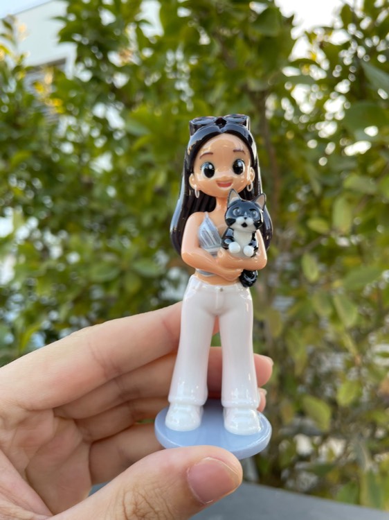 Figurine of a young woman holding her husky puppy